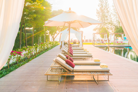 Umbrella and chair deck in hotel resort swimming pool - Filter effectのeditorial素材