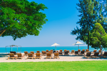 Umbrella pool and chair in luxury hotel pool resort on the beach - Filter Processing styleのeditorial素材