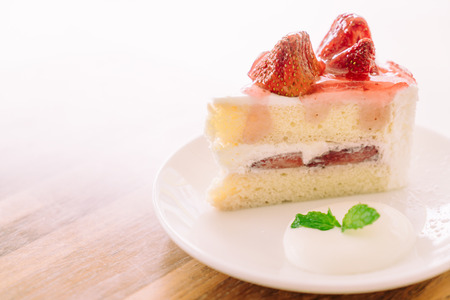 Soft focus on Strawberry cream cake in white plate - filter effect processingの写真素材