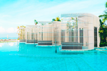 Beautiful luxury hotel swimming pool with umbrella and beach chair - Vintage Filter effectの写真素材