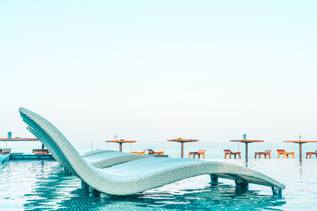 Umbrella and chair pool around beautiful luxury hotel swimming pool - Vintage Filter