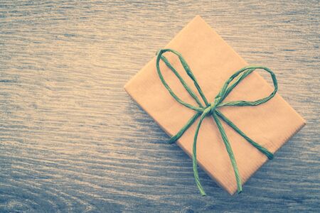 Vintage Brown gift box on wooden background - vintage filter processingの写真素材