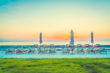 Beautiful luxury hotel swimming pool resort with umbrella and chair - Vintage filterの写真素材