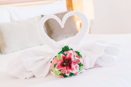Beautiful flower and swans towels decoration on bedroom - Filter effectの写真素材