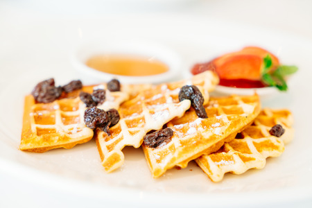 Soft focus point on Waffle dessert with strawberry jam and honey syrup - Filter effectの写真素材