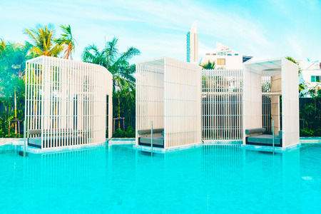 Beautiful luxury hotel swimming pool with umbrella and beach chair - Vintage Filter effectのeditorial素材