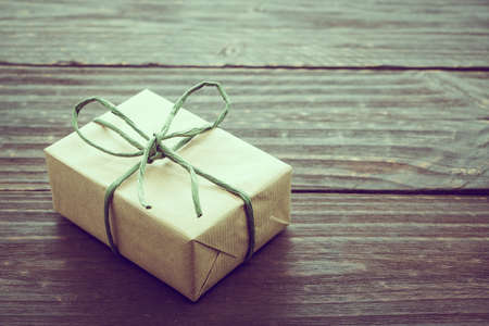 Vintage Brown gift box on wooden background - vintage filter processing