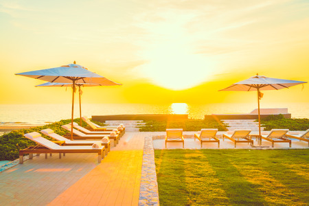 Beautiful luxury hotel swimming pool resort with umbrella and chair - Vintage filterの写真素材