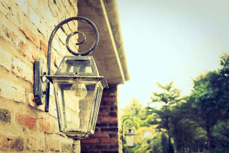 Old lantern decoration on wall - Vintage filterの写真素材