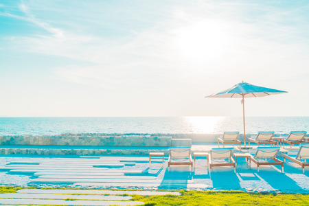 Beautiful luxury hotel swimming pool resort with umbrella and chair - Vintage filter