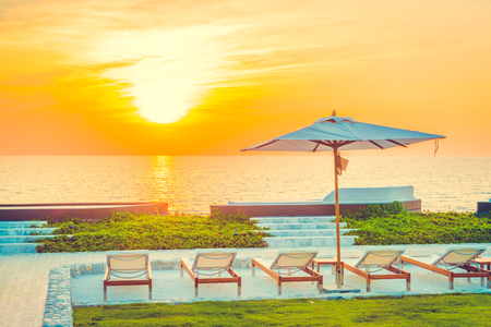 Beautiful luxury hotel swimming pool resort with umbrella and chair - Vintage filterの写真素材