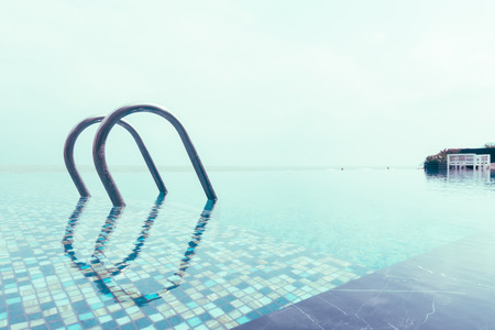 Swimming pool with stair in hotel pool resort - Vintage Filterの写真素材