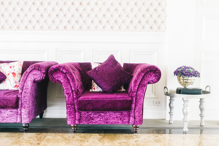 Beautiful luxury purple sofa with pillow decoration in livingroom interior - Vintage Film Filter