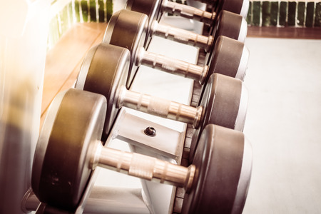 Soft focus point Dumbbell equipment in fitness gym room - Vintage Filterの写真素材