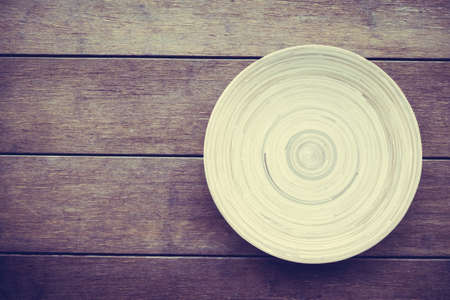 Top of view with Empty wood plate dish on wooden background - Vintage Filter