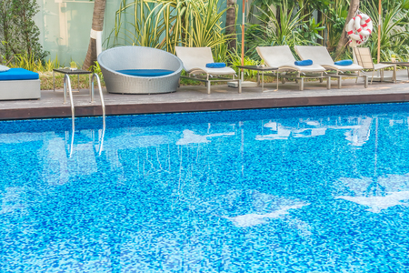 Umbrella and chair around beautiful luxury swimming pool in hotel resortのeditorial素材