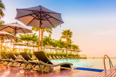 Beautiful luxury swimming pool with umbrella and chair in luxury hotel resort - Vintage Filter and Boost up color Processing styleのeditorial素材