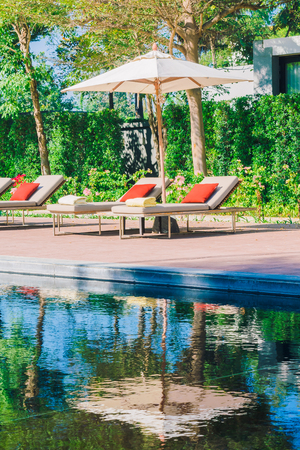 Umbrella pool and chair in beautiful luxury hotel pool resort - Filter Processing style picturesのeditorial素材