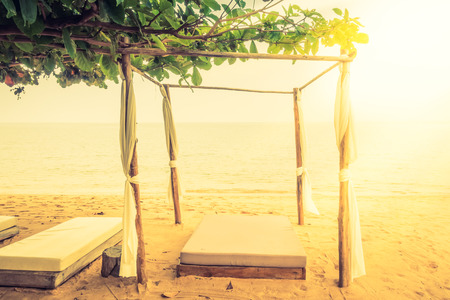 Beautiful vintage beach and sea with deck , chair and umbrella - Vintage Filter and Sunflare effect