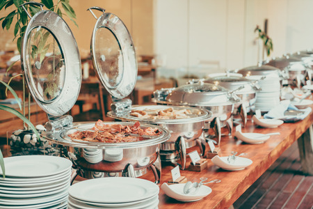 Selective focus point on Catering buffet in hotel restaurant - Vintage filter effectの写真素材