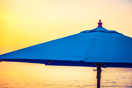 Beautiful luxury hotel swimming pool resort with umbrella and chair on the beach and sea - Vintage Filter and Boost up color Processingの写真素材
