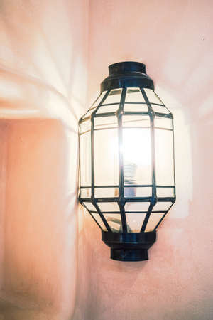 Lantern light lamp decoration on wall - Vintage film Filterの写真素材
