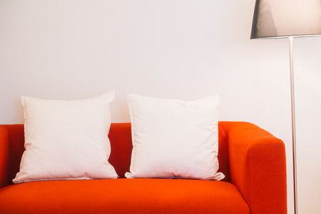 Red sofa with pillow and light lamp decoration in living room interior - Vintage Light Filterの写真素材
