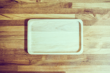 Old wooden plate on wooden background - Vintage Filterの写真素材