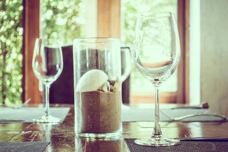 Empty wine glass on dining table in restaurant -  Vintage Filter and Selective focus pointの写真素材