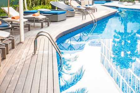 Umbrella and chair around beautiful luxury swimming pool in hotel resortのeditorial素材