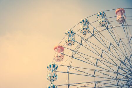 Vintage ferris wheel on blue sky background in the park - Vintage Filterの写真素材