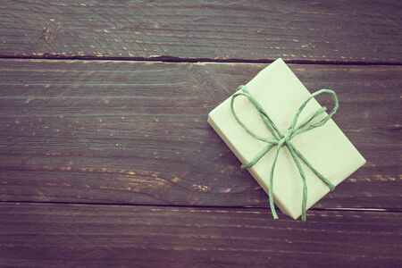 Vintage Brown gift box on wooden background - vintage filter processingの写真素材