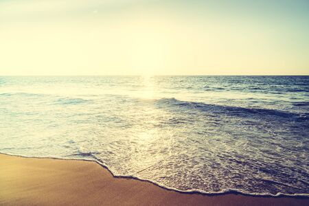 Beautiful Sunset with sea and beach - Vintage and sunflare filter effectの写真素材