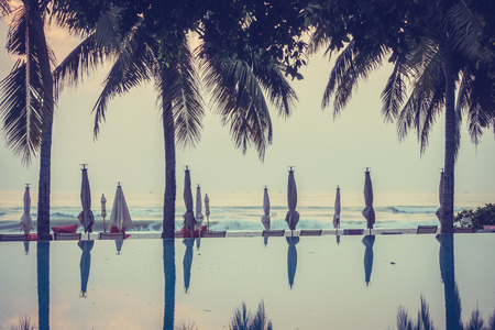 Beautiful luxury swimming pool in hotel pool resort with umbrella beach and chair - Vintage Filterの写真素材