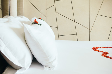 Honeymoon bed decoration with swan towel with rose flower decoration in bedroom interior - Vintage Light Filterの写真素材