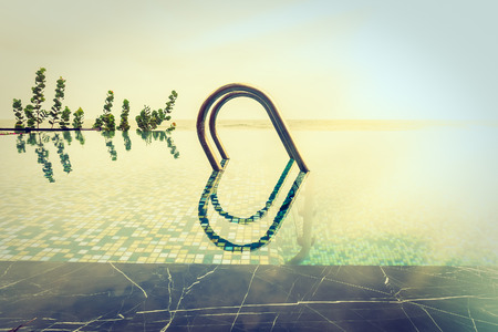 Beautiful luxury Swimming pool resort hotel with stairs pool - Vintage Filter and sunflare effect processingのeditorial素材