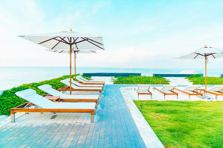 Beautiful luxury hotel swimming pool with umbrella and beach chair - Vintage Filter effect