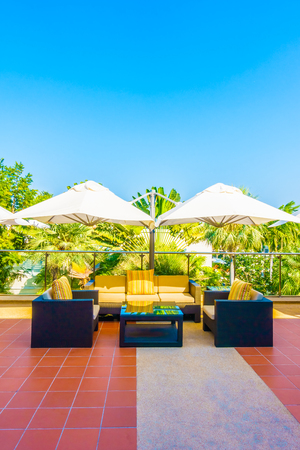 Outdoor deck with umbrella and chairの写真素材