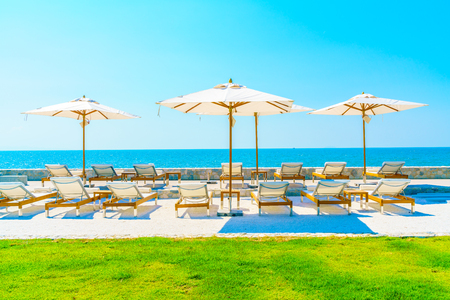 Beautiful luxury hotel swimming pool resort with umbrella and chairの写真素材