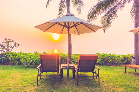 Empty umbrella and chair on the beach at Twilight Times - Vintage Filterの写真素材