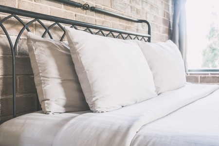 Pillows on bed decoration in bedroom interior - Vintage filterの写真素材