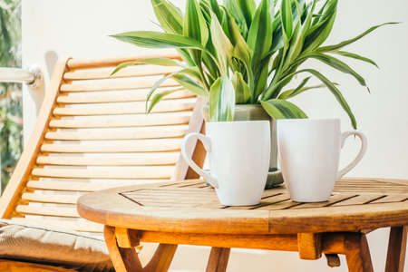 White coffee cup on table around outdoor deck - Vintage Light Filter