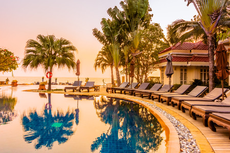Beautiful luxury umbrella and chair around swimming pool in hotel resort at Sunset times - Vintage Filter and Boost up Color Processingのeditorial素材