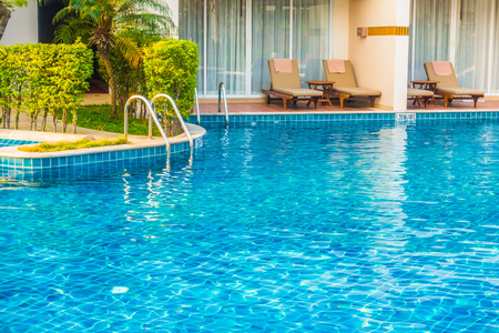 Empty Umbrella and chair around swimming pool in hotel resortのeditorial素材