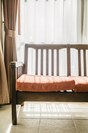 Empty wooden sofa and chair decoration in living room interior - Vintage Filterの写真素材