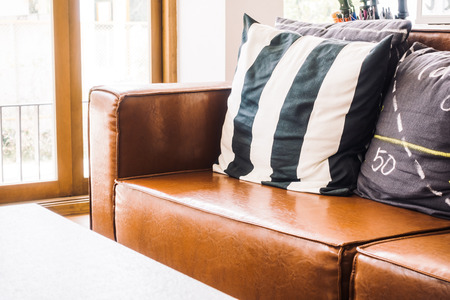 Beautiful luxury pillow on sofa decoration in living room interior - Vintage light Filterの写真素材