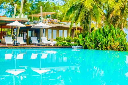 Beautiful luxury swimming pool in hotel pool resort with umbrella beach and chair - Vintage Filter and Boost up color Processingのeditorial素材