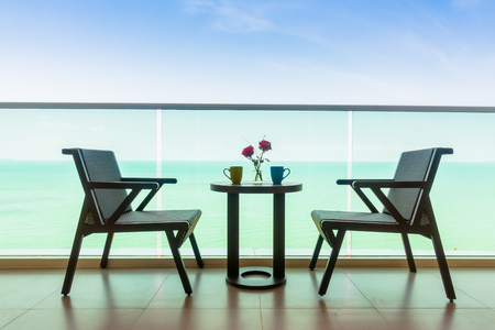 Table and chair with outdoor balcony and sea background - Vintage Filter and Boost up color Processingの写真素材