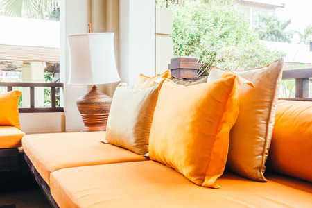 Empty wooden sofa with pillow and chair decoration in living room interior - Vintage Filterの写真素材