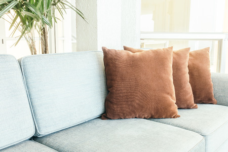 Beautiful luxury pillow on sofa decoration in living room interior - Vintage Light filterの写真素材